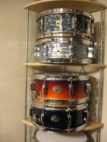 Here is a great inexpensive shelf for snare display $39.00