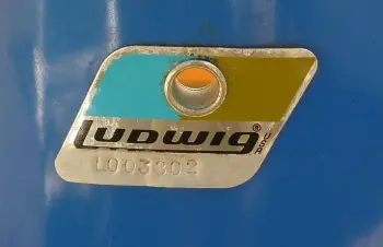 Blue/Olive badges with L before the serial?